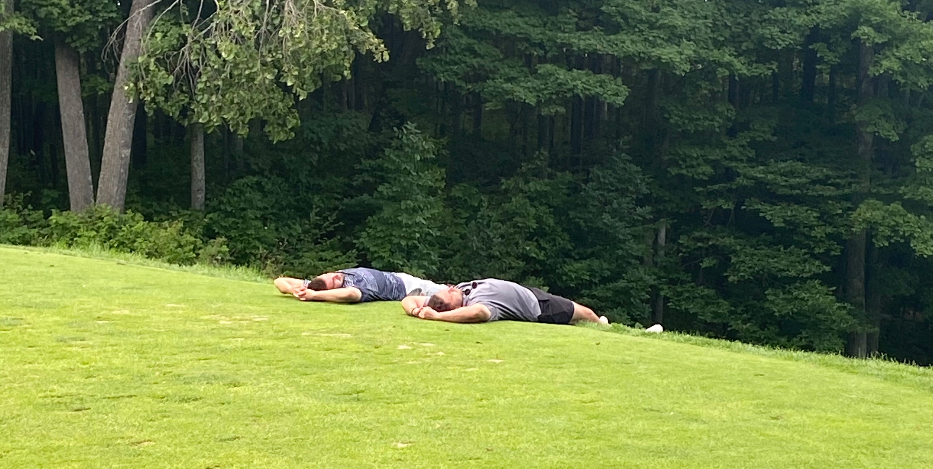 two guys relaxing on a teebox
