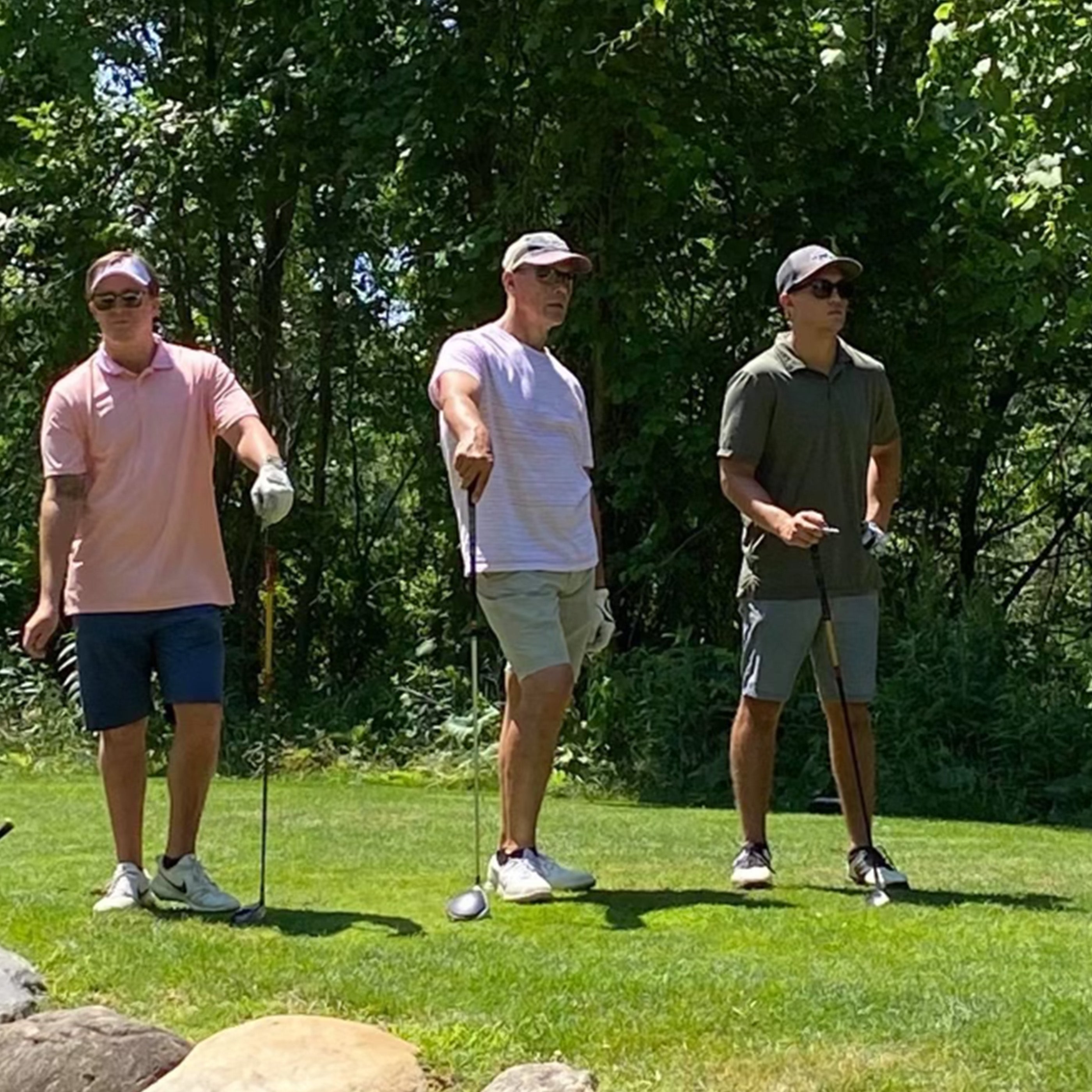 3 golfers on a tee box